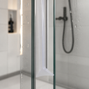 Clear seal with a lilac wave-shaped foot, fitted at the base of a shower door corner.