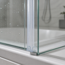 Clear twin-bulb seal fitted vertically along a glass panel edge, shelf with bottles behind.