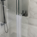 Clear dome-loop seal fitted vertically along a glass edge, niche shelf with a bottle behind.