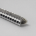 Single length of brush seal end-on, clear carrier with twin black rows and long grey bristles