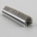 Angled view of brush seal showing the clear T base channel and evenly trimmed grey bristles
