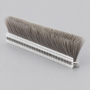 Side view of a brush seal length showing the flat clear carrier and upright grey bristles