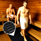 Black modular matting laid on the floor of a wood-panelled sauna, two men in towels.