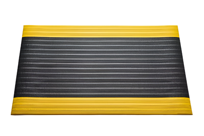 Black anti-fatigue noise reducing mat with a ribbed non-slip surface and high-visibility yellow safety borders. This product shot showcases the durable PVC foam cushioned mat, ideal for workstations, garages, and industrial areas.