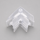 Clear V-shaped corner piece with screw hole and stepped side flanges on a plain grey background