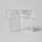 Clear moulded corner piece on pale grey - two channel arms meeting at a right angle above a stepped base