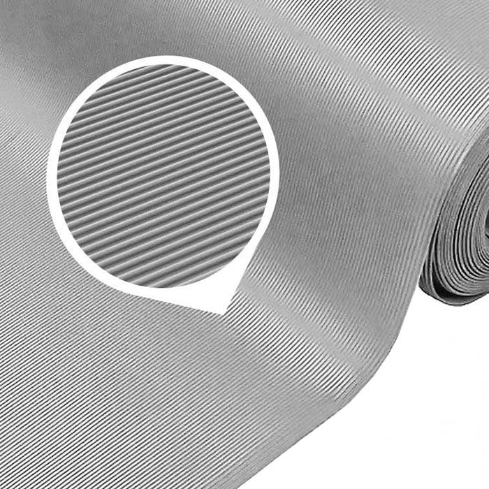 Close-up of a large roll of light grey fine ribbed PVC matting, highlighting the narrow corrugated pattern of the slip-resistant surface. This mat is sold as a 1m x 25m roll and is chemical and oil resistant for use in commercial and industrial settings.