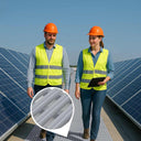 Grey roof walkway matting laid between rows of rooftop solar panels, two workers in hi-viz.