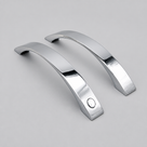 Two curved chrome shower handles side by side on grey, one with a round button on its face