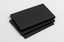 Three matt black polypropylene sheets stacked and fanned on a plain pale grey background