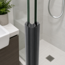 Dark grey magnet caps on clear seal fitted at shower door, plant and tiling behind