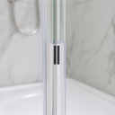 Clear seal pair fitted at glass shower door join, chrome tap and plant alcove behind