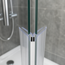 Clear V-shaped seal fitted at door corner, grey magnets, vanity and window plant behind