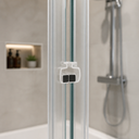 Close-up of white magnetic clip joining two black magnet strips on shower door