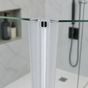 Blue-clipped seal fitted at glass door join, chrome tap and plant behind