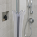 Clear seal fitted at glass shower door edge, floor drain and wooden shelf plant behind