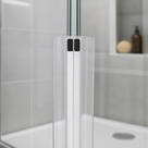 Two clear magnetic seals closing on a glass door edge, grey tiles, niche and a white tray with a round waste behind