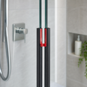 Black seal pair with red end caps fitted at glass door gap, chrome mixer tap behind