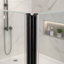 Chrome-effect seal rail fitted at glass door edge, black magnet clips and vanity behind