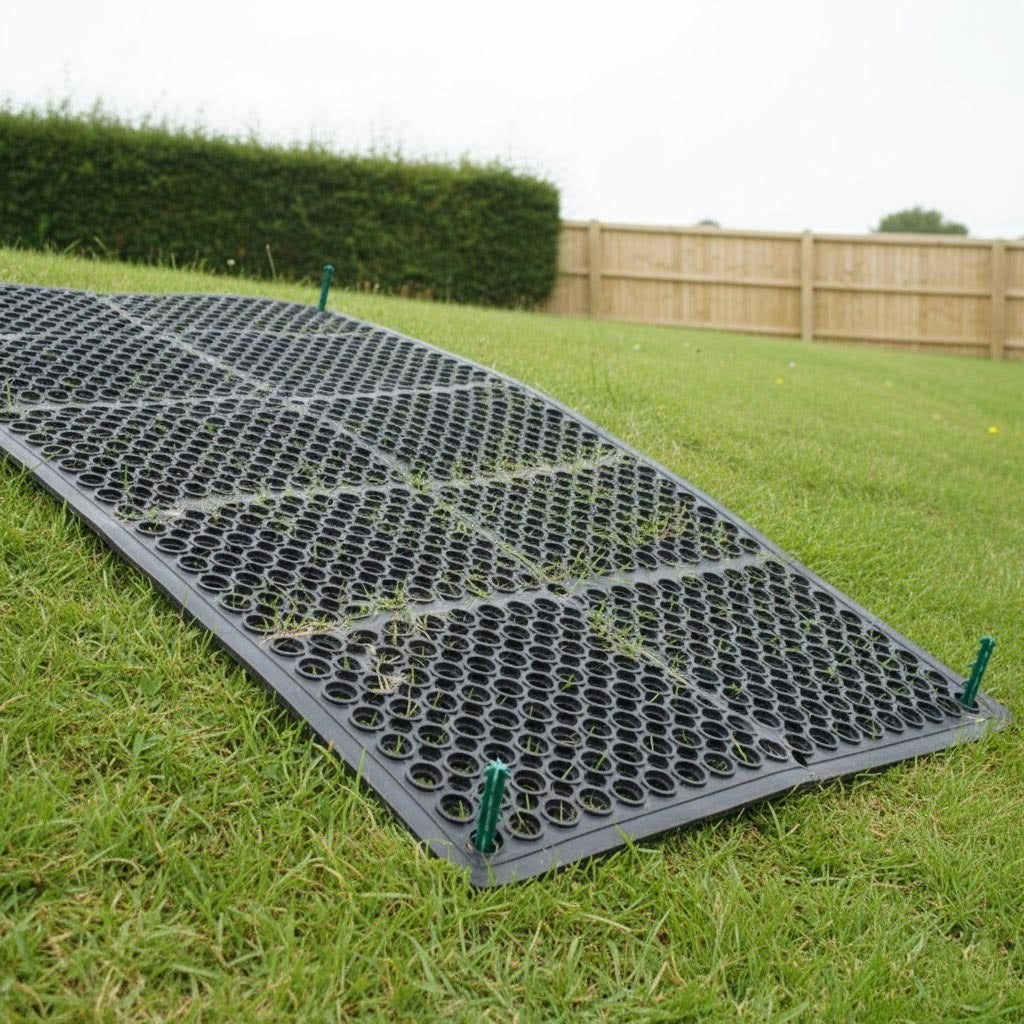 Rubber grass protection mat installed on grassy slope for erosion control and non-slip ground stabilisation