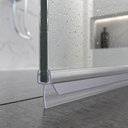 Seal fitted to a glass shower door edge, with a recessed shelf and bottle visible behind