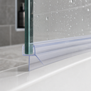 Pre-curved seal fitted to a glass door edge on a white shower tray, bottle on shelf behind