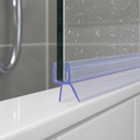 Clear T-fin seal fitted to a glass edge on a white shelf, tiled wall with droplets behind