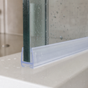 Clear seal fitted to a glass door edge on a marbled white counter surface