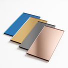 Four acrylic mirror rectangles fanned on white in blue, gold, grey and rose, polished reflective faces