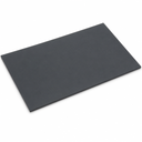 Thin dark grey PVC sheet lying flat at an angle on a white studio background