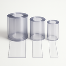 Three clear PVC strip curtain rolls in descending widths on white, a loose strip unrolled from each