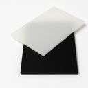 Translucent milky white polypropylene sheet lying at an angle across a matt black sheet on a plain white background