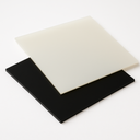 Off-white translucent polypropylene sheet resting on a black sheet of the same size against a white backdrop