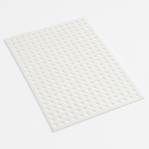 White perforated polypropylene sheet angled on a plain white studio background, round holes in a regular grid