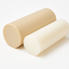 Two short polypropylene rod offcuts lying on white, one beige and one off-white, cut ends to camera