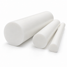 One stout and two slim white PTFE bars grouped on white, round cut ends towards the front