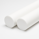 Two large white PTFE rods side by side on a plain white background, flat cut faces angled towards the camera