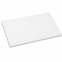 White PTFE slab lying flat and angled on white, matt face with a square-cut edge showing its depth