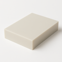 Single off-white glass filled PTFE block on a plain white background, viewed at an angle from above