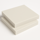 Two cream glass filled PTFE slabs stacked offset on white, thick square edges visible from above