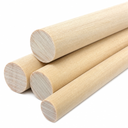 Four pale cream phenolic laminate rods stacked on white, fine grain showing on the cut ends