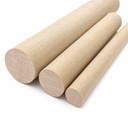 Three tan phenolic laminate rods of different diameters on white, woven fabric grain in the end faces