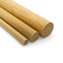 Four pale gold phenolic laminate rods laid in a fan on white, round cut ends to the right