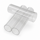 Three clear acrylic tubes crossed in a stack, cut ends towards the camera, on a plain white studio background.