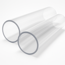 Two wide-bore clear acrylic tubes lying side by side on white, thick sawn wall ends towards the camera