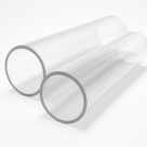 Two wide-bore clear acrylic tubes lying side by side on white, thick sawn wall ends towards the camera