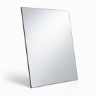 Portrait silver acrylic mirror standing upright on white, thin dark backing showing down the left-hand edge