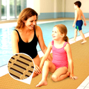 Tan modular matting at an indoor pool edge, with a mother and two children beside the water.