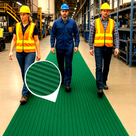 Three factory workers, two in hi-viz vests, walk down a green ribbed PVC matting runner, inset close-up of the ribs