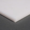 White polypropylene sheet corner shot from above on grey, showing the slab depth at the edge